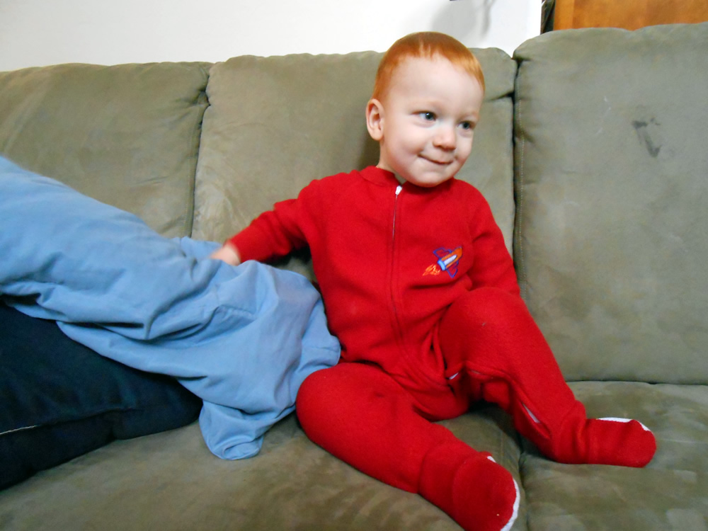 Felix looking cute in his red rocket PJs. We finally talked him down to start opening presents.
