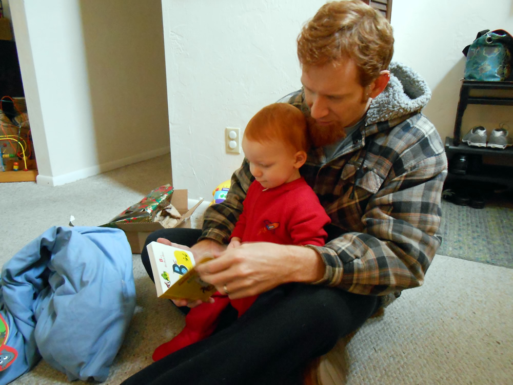 Checking out a new book. He took time to play with every present he opened before moving to the next.